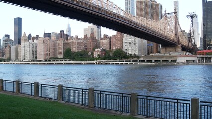 New York City waterfront skyline, Queensboro Bridge, Manhattan Midtown buildings, riverfront skyscrapers. Waterside cityscape view from Roosevelt Island. United States architecture and real estate.