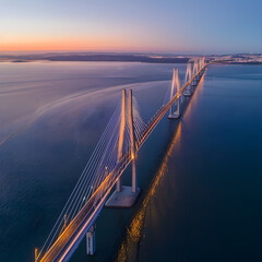 Obraz premium Vasco da gama bridge crossing river tejo at sunset, lisbon, portugal