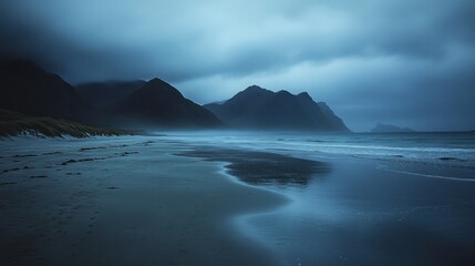 Dramatic landscape view of sea and mountains on a remote beach in the Lofoten Islands with soft light and serene atmosphere