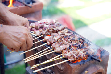 Grilling Sate Klathak, a typical Yogyakarta satay dish made from young goat meat (lamb) without...