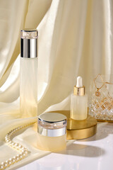 High-end cosmetic kit advertising photo was taken from high angle view. Cosmetic bottle, small vial...