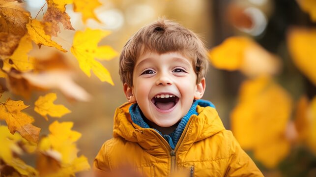A joyful young boy in a yellow jacket laughing amidst falling golden autumn leaves, capturing the essence of playful childhood fun in the fall season.