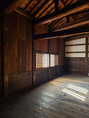 A serene and minimalist Japanese-style room ; A traditional Japanese interior with wooden beams and tatami mats