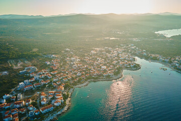 Aerial view of Adriatic sea coastline with coastal village and boats along shoreline. Panorama of tourist town Rogoznica in Croatia on Adriatic Sea. Summer travel concept