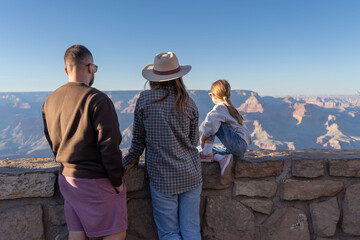 Family enjoy view of Grand Canyon, National Park. USA
