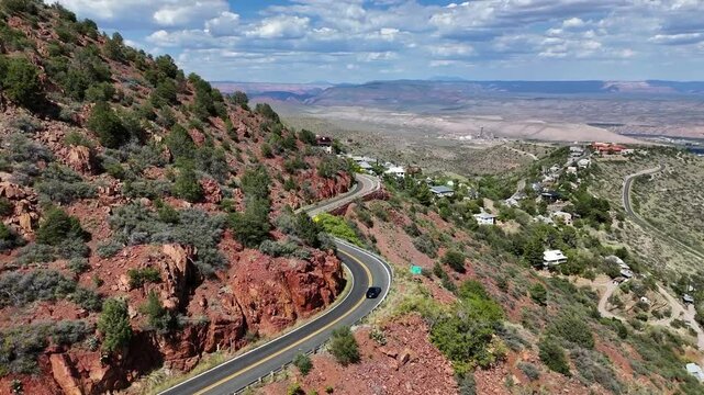 Aerial View of Car Driving on a Mountain Road with Sharp Turn. Highway 89A to Jerome, Arizona