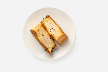 Cut in half croissant onigiri dessert on white plate isolated on white background