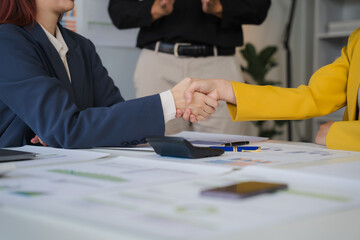 Deal Sealed: A confident handshake signifies a successful business agreement, as two professionals seal the deal in a boardroom setting. The image exudes professionalism and trust. 