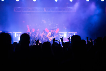 Crowd at concert and blurred stage lights.
