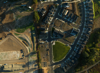 A view of a residential neighborhood with houses and a park