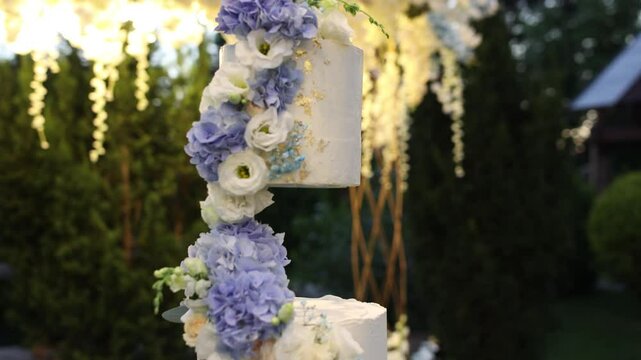 a large white wedding cake near the wedding arch