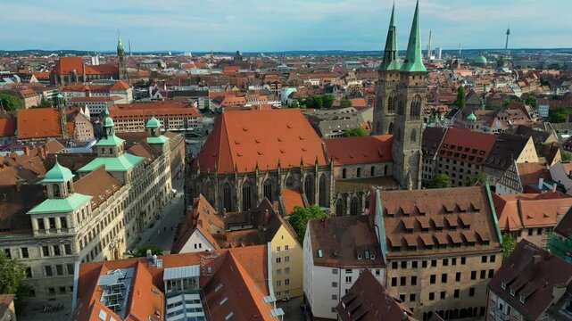 4K Aerial Drone Video of the Copper-clad Twin Spiers and Stained Glass Windows of the Beautiful St. Sebald Church in Downtown Nurnberg, Germany