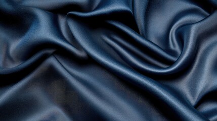 Fototapeta premium Dark blue silk fabric background with smooth flowing texture