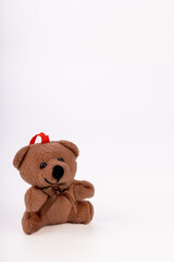 Festive teddy bear ornament with Santa hat on a white background