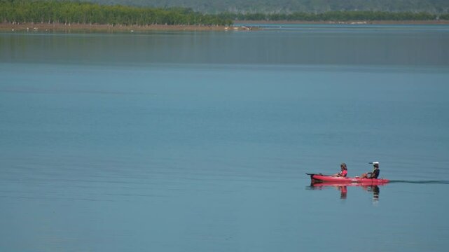 Unrecognizable couple kayaking at Lake Proserpine a rural locality in the Whitsunday Region, Queensland, Australia.In the 2021 census, Lake Proserpine had a population of 6 people