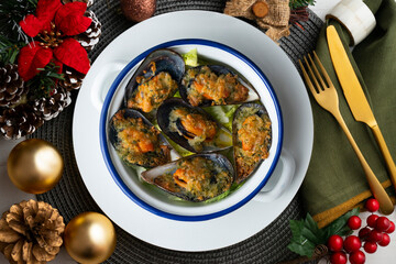 Mussels au gratin with parsley, oil and bread. Top view table with Christmas decorations.