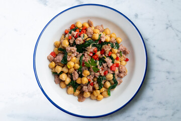 Catalan pork sausage with chickpeas and spinach. Top view table with  decorations.