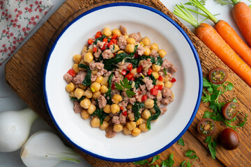 Catalan pork sausage with chickpeas and spinach. Top view table with  decorations.
