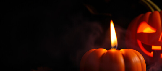 Lit Pumpkin With Smoke And A Jack O Lantern In The Background
