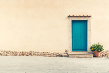 A vibrant turquoise door against a textured wall with a potted plant in a quiet outdoor area during daylight