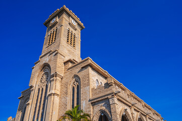 Tower on Nha Trang Cathedral or Stone Church or Christ the King Cathedral in Vietnam against a blue sky background