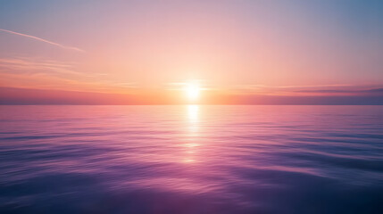 Obraz premium Calm ocean horizon with the sun setting, displaying pastel hues in the sky and water, embodying serenity and peace.