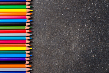 Colorful pencils on dark table
