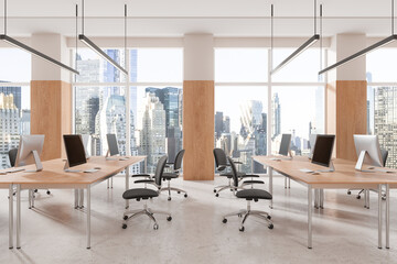 Office coworking interior with pc monitors in row, panoramic window