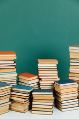 Stacks of educational books for learning in the library as a background