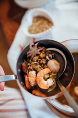 plate soup with sea products with bread as background