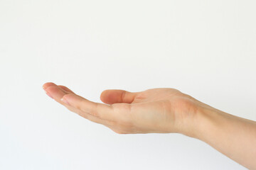 Close-up of empty woman hand isolated on grey background with clipping path