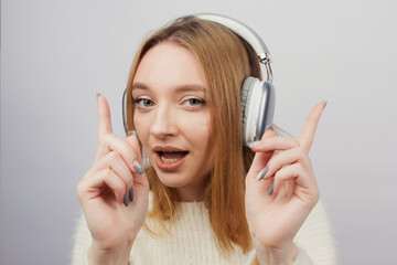 Fototapeta premium Girl listening to music on headphones on white background