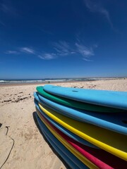 Surf Boards on the sand in Portugal. Atlantic Ocean. Surfing in Peniche.