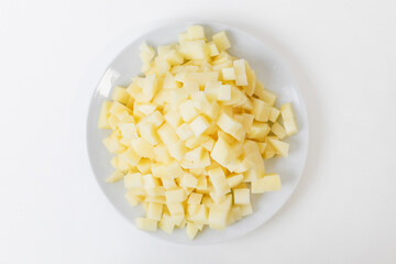 Chopped potatoes on a white plate, ideal for cooking healthy meals and Thanksgiving side dishes