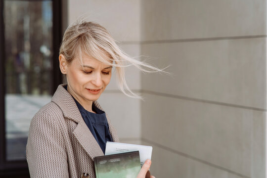 Businesswoman with tousled hair holding diary