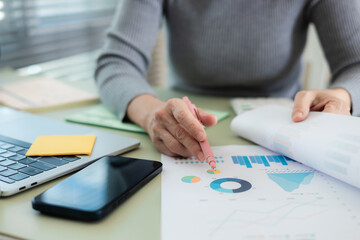 Close-up of business professional handling financial documents at a desk