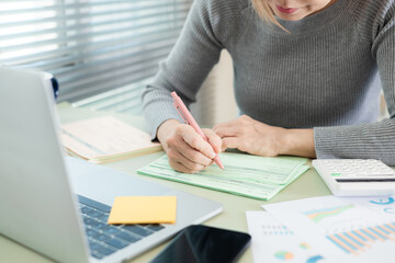 Close-up of business professional handling financial documents at a desk