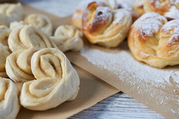 Close-up of the buns on baking paper with powdered sugar