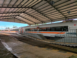 Indonesian railway. A bustling railroad station platform with a train waiting on the tracks. Selective focus.