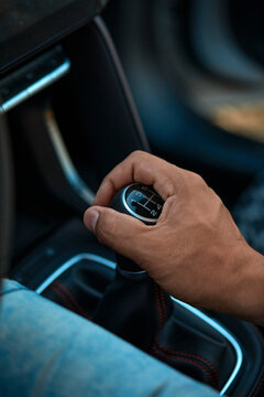 Man shifting gear of car