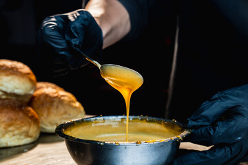The chef is mixing a mayonnaise sauce for the burger to check its texture