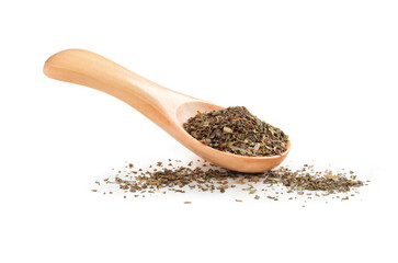 Dried basil in a wooden spoon isolated on a white background. Seasoning for cooking