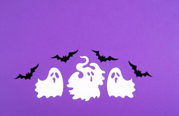 Three playful ghosts and bats on a vibrant purple background for Halloween decoration