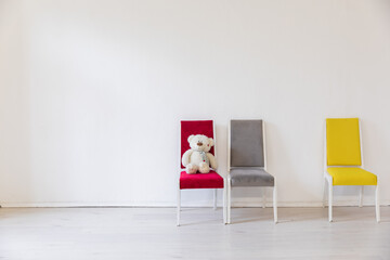 Fototapeta premium Three old vintage chairs in the interior of an empty white room
