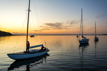 Sailing boats coming back into the harbour during scenic sunset at the Baltic Sea in Northern...