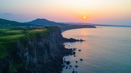 Fototapeta premium The stunning coastal view from the cliff at Seogwipo in Jeju, known for its breathtaking sunsets.
