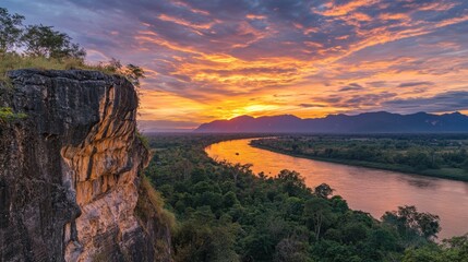 The stunning cliffs of Pha Taem National Park at sunrise, overlooking the Mekong River and Laos beyond.