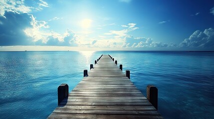 Obraz premium Wooden dock jutting into azure sea beneath radiant blue sky with fiery sun overhead