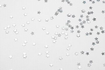 sparkles silver stars on white background with text place- Image