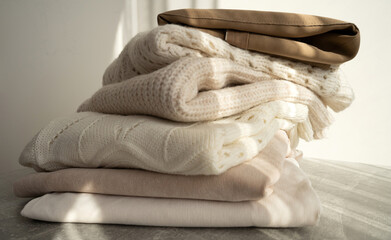 Stack of Cozy Knit Sweaters in Natural Light